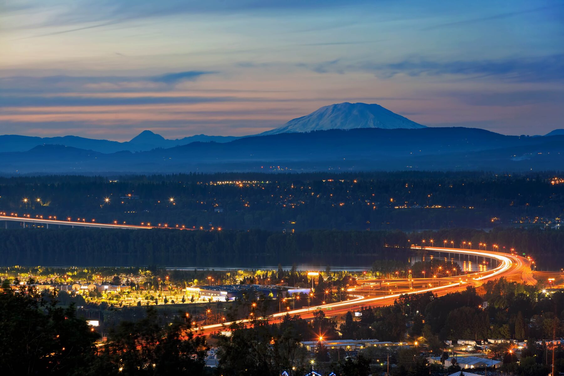 nighttime view of a beautiful city skyline and mountains