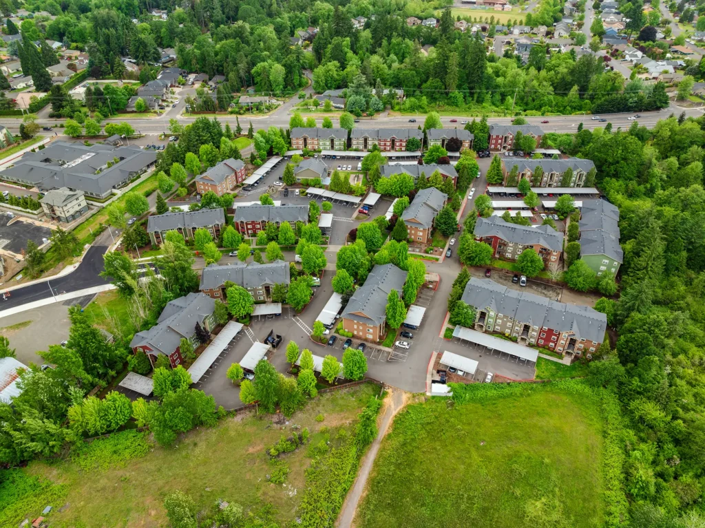 Aerial view of Willamette Park apartments surrounded by lush green forest.
