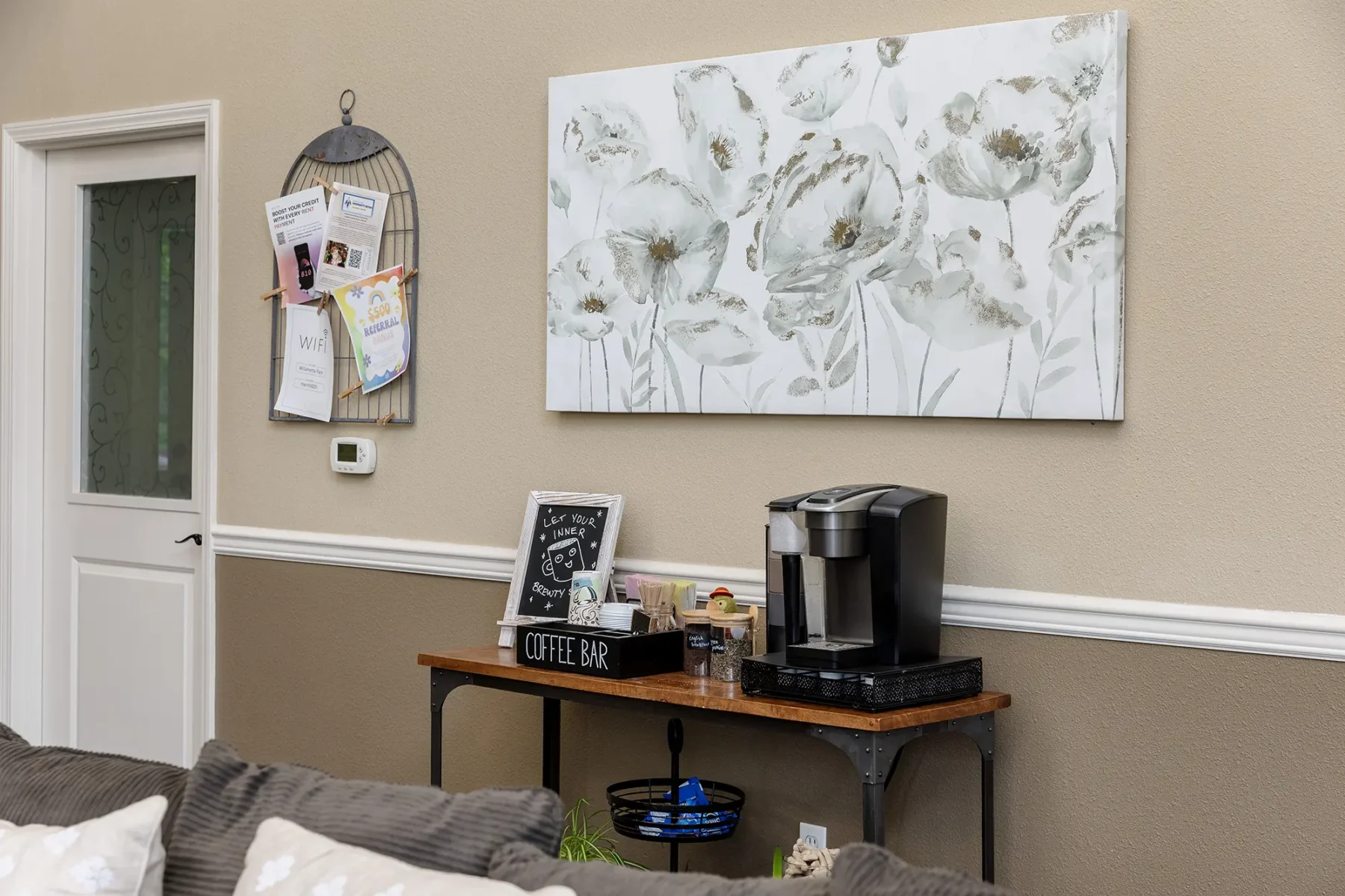 Coffee bar in clubhouse under a decorative piece of wall art.
