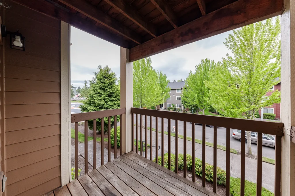 Private covered balcony with view of exterior apartment units.