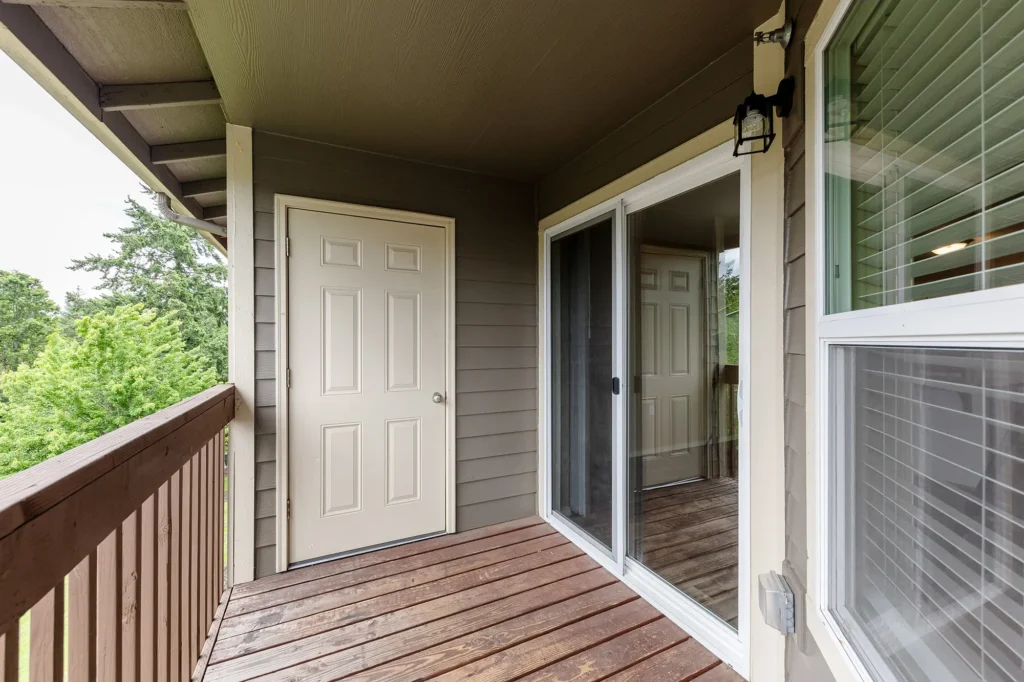 Private covered balcony with storage door and sliding glass entrance.