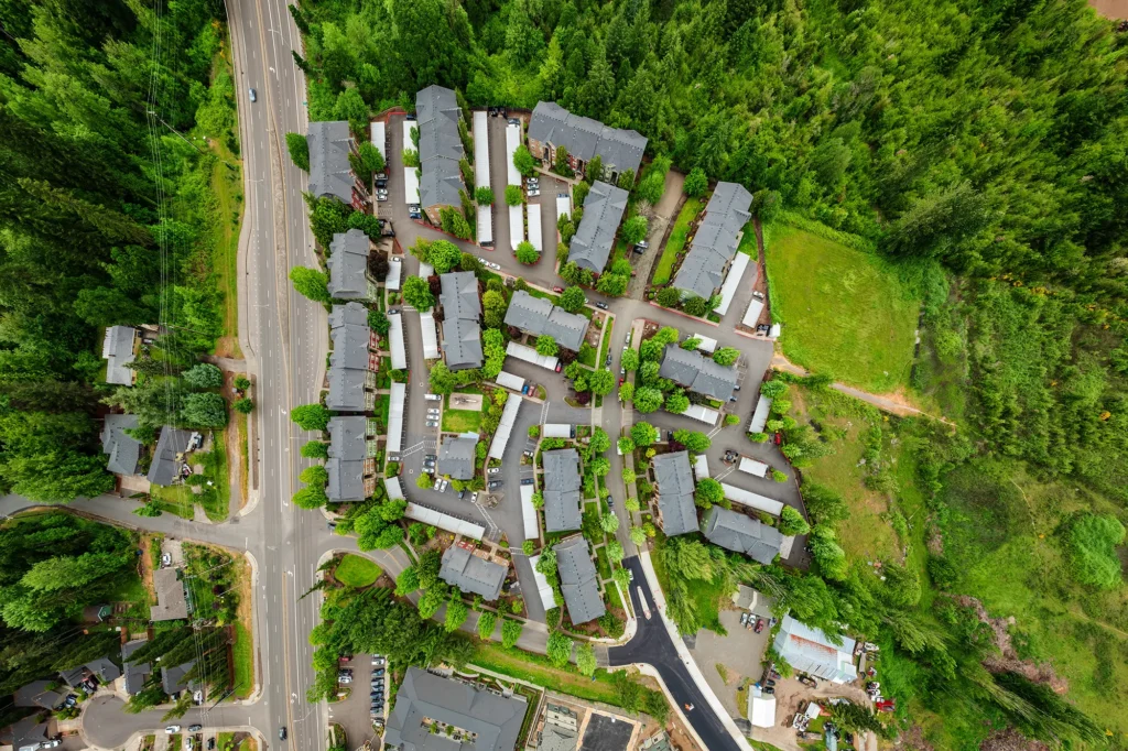 Aerial view of Willamette Park apartments surrounded by lush green forest.